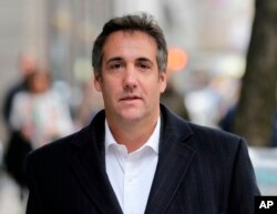 FILE - Michael Cohen, President Donald Trump's personal attorney, walks along a sidewalk in New York, April 11, 2018.