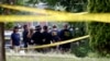 Investigators confer before looking for evidence around the baseball field in Alexandria, Virginia, June 14, 2017, that was the scene of a shooting involving House Majority Whip Steve Scalise, and others, during Congressional baseball practice.