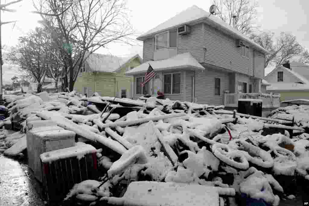 A pile of garbage in the street is covered with snow in the New Dorp section of Staten Island, New York, November 8, 2012. 