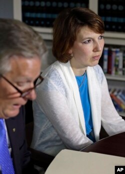 FILE - Tanya Fowle, right, wife of Jeffrey Fowle, listens as attorney Tim Tepe reads a statement from the family in Lebanon, Ohio.
