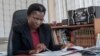 FILE - Martha Chizuma works at her desk before talking to Agence France-Presse in her office in Lilongwe, Malawi, Sept. 9, 2019.
