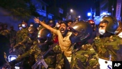 A Sri Lankan man shouts anti-government slogans during a protest outside the Sri Lankan president's private residence on the outskirts of Colombo, Sri Lanka, March 31, 2022. 