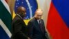 FILE - South Africa's President Cyril Ramaphosa, left, and Russia's President Vladimir Putin arrive for the Leaders Dialogue with BRICS Business Council and the New Development Bank, at the Itamaraty Palace in Brasilia, Brazil, Nov. 14, 2019.