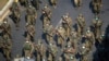 Tentara Myanmar dalam menghadapi protes warga di Yangon, Myanmar, 28 Februari 2021. Helikopter pemerintah Myanmar telah menyerang sebuah sekolah dan desa di bagian utara-tengah negara Asia Tenggara itu, menewaskan sedikitnya 13 orang termasuk tujuh anak-anak. (Foto: Reuters)