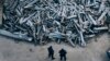 Police officers look at collected fragments of the Russian rockets that hit Kharkiv, in Kharkiv, Ukraine, Dec. 3, 2022. 