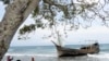 A wooden boat is used to carry RohingyaÊrefugees rest at a beach in Ladong village Indonesia, December 25, 2022.