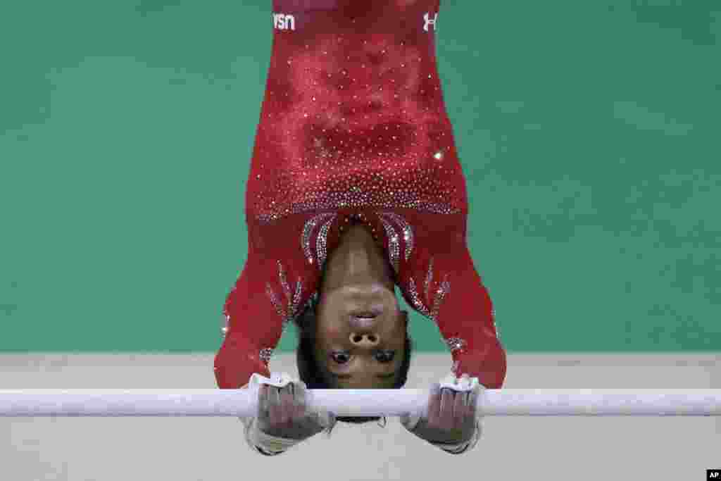 United States' Gabrielle Douglas trains on the uneven bars ahead of the 2016 Summer Olympics in Rio de Janeiro, Aug. 4, 2016.