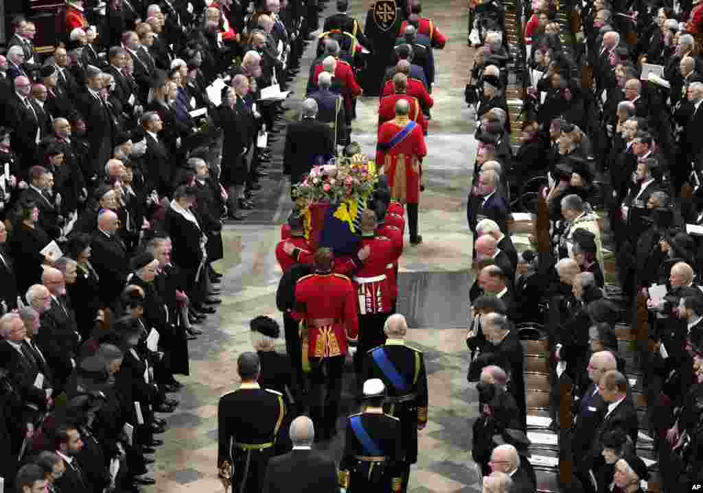 World leaders pay their respects as the coffin of Queen Elizabeth is being carried into Westminster Abbey for her funeral in central London, Sept. 19, 2022.