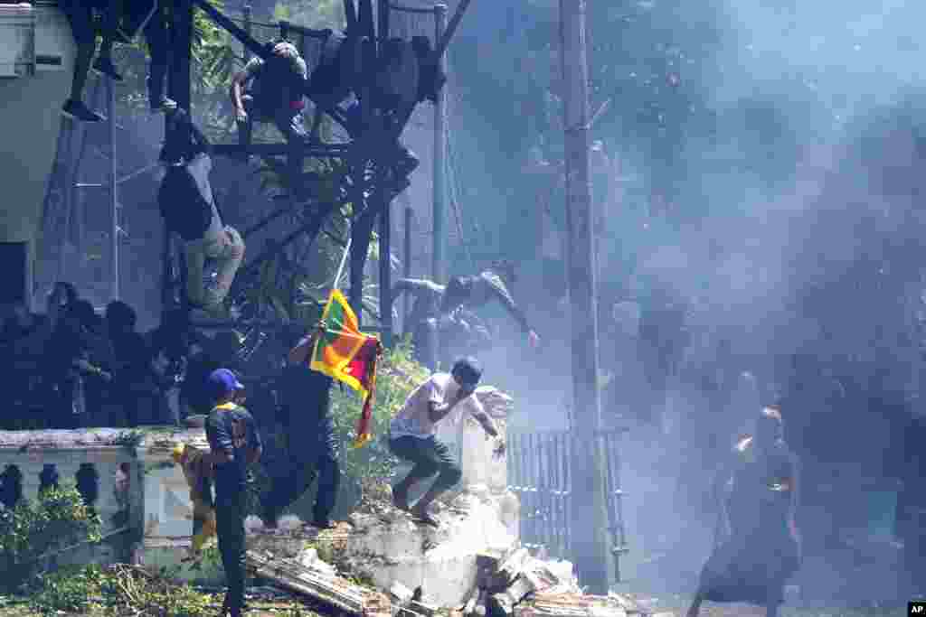 Protesters storm the Sri Lankan Prime Minister Ranil Wickremesinghe's office in Colombo, July 13, 2022.