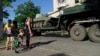 Russian military vehicles move through the city of Mariupol on July 15, 2022, amid the ongoing Russian military action in Ukraine. 