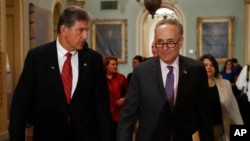 FILE - Sen. Joe Manchin, D-W.Va., left, and then-Senate Minority Leader Chuck Schumer, D-N.Y. arrive for a news conference on Capitol Hill in Washington, May 2, 2017.