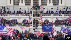 FILE - Insurrectionists loyal to President Donald Trump breach the Capitol in Washington, Jan. 6, 2021.