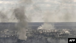 Smoke and dirt rise from shelling in the city of Sievierodonetsk during fight between Ukrainian and Russian troops in the eastern Ukrainian region of Donbas on June 7, 2022. (Photo by Aris Messinis / AFP)