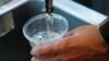 FILE - A cup of water is drawn from a faucet at Johnny T's Bistro and Blues, a midtown Jackson, Miss., restaurant and entertainment venue, Sept. 1, 2022. Although it is no longer cloudy, owner John Tierre said he has concerns over the city's longstanding 