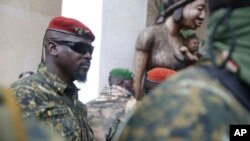 FILE - Guinea's Junta President Col. Mamady Doumbouya leaves a meeting with an ECOWAS delegation in Conakry, Guinea, Sept. 10, 2021.