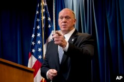 File - In this Dec. 5, 2017, photo, then Acting Director for U.S. Immigration and Customs Enforcement Thomas Homan takes a question from a reporter at a Department of Homeland Security news conference in Washington.