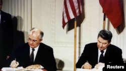 FILE - U.S. President Ronald Reagan (R) and Soviet President Mikhail Gorbachev sign the Intermediate-Range Nuclear Forces (INF) treaty in the White House Dec. 8, 1987.