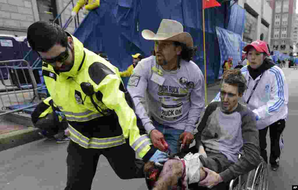 Petugas tanggap medis membawa korban luka pada Marathon Boston (15/4). (AP/Charles Krupa)