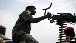 FILE - A government soldier mans a vehicle-mounted machine gun in the oil-rich town of Malakal, South Sudan. OCHA says humanitarian partners have "rapidly mobilized" staff and supplies to tend to the additional needs at the camp since the attack.