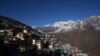 Joshimath town is seen along side snow capped mountains, in India's Himalayan mountain state of Uttarakhand, Jan. 21, 2023. For months, residents in Joshimath, saw their homes slowly sink. In January, big, deep cracks had emerged in over 860 homes, making them unlivable. 