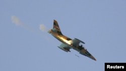 A Syrian Air Force fighter plane fires a rocket during an air strike in the village of Tel Rafat, some 37 km (23 miles) north of Aleppo, August 9, 2012. 