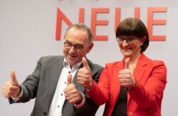 Norbert Walter-Borjans and Saskia Esken celebrate after their election to SPD chairpersons at the Social Democratic Party convention in Berlin, Germany, Dec. 6, 2019.