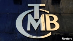 FILE - The logo of Turkey's Central Bank (TCMB) is seen at the entrance of the bank's headquarters in Ankara, Turkey, April 19, 2015.