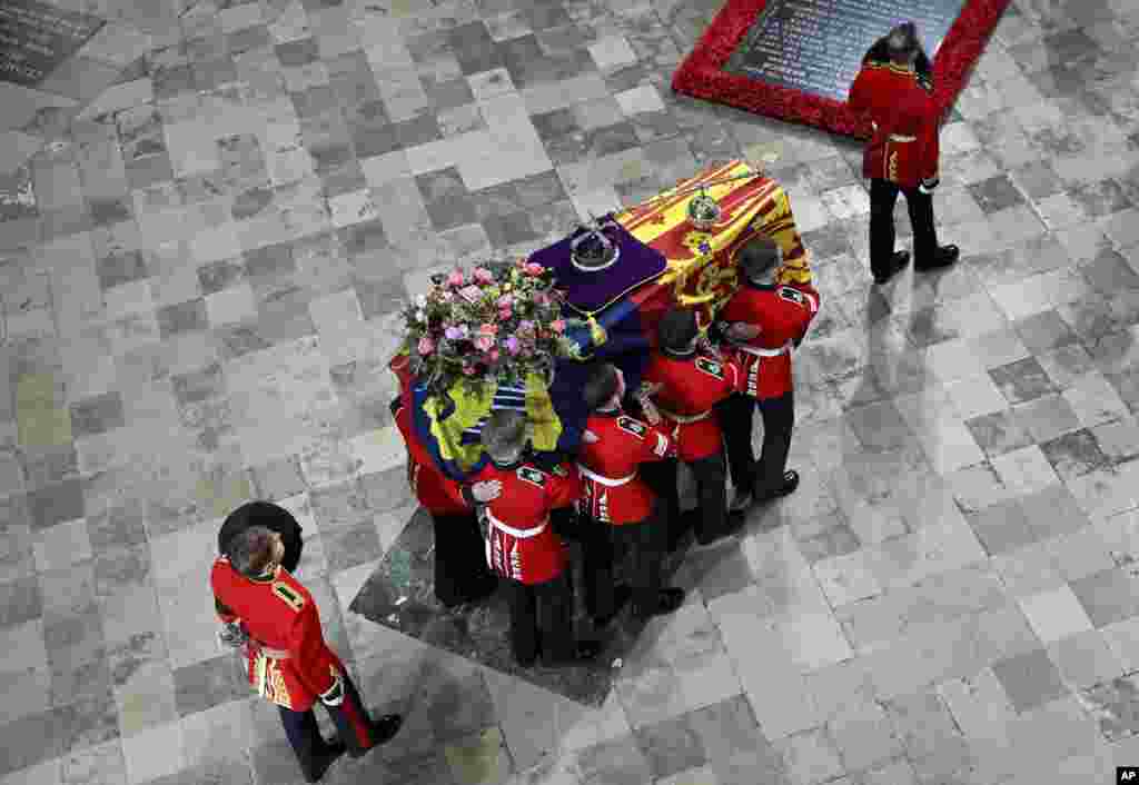The coffin of Queen Elizabeth II is carried into Westminster Abbey ahead of her State Funeral, in London, Sept. 19, 2022.