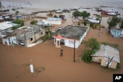 Homes are flooded on Salinas Beach after the passing of Hurricane Fiona in Salinas, Puerto Rico, Monday, Sept. 19, 2022.