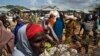 FILE - Somali refugees organize their food rations during a distribution exercise outside a U.N. World Food Program center at the Dadaab refugee settlement in Kenya, October 2013.