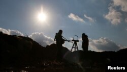 Free Syrian Army fighters stand in the east of the rebel-held town of Dael, in Deraa Governorate, Syria, Jan. 3, 2017.