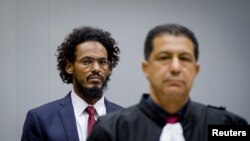 FILE - Ahmad Al Faqi Al Mahdi enters the courtroom of the International Criminal Court in the Netherlands