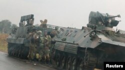 FILE: Soldiers stand beside military vehicles just outside Harare, Zimbabwe, Nov. 14,2017.