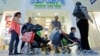FILE - Shoppers walk through a mall in Miami, Florida, Feb. 12, 2016.