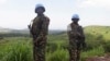 FILE - UN peacekeepers from Tanzania hold their weapons as they patrol outside Goma.