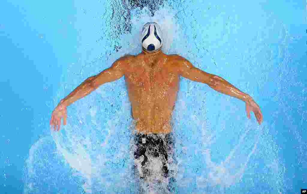 Michael Phelps swims in the men's 200-meter butterfly preliminaries at the U.S. Olympic swimming trials in Omaha, Nebraska.