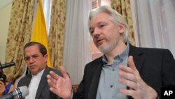FILE - Ecuador's Foreign Minister Ricardo Patino, left, and WikiLeaks founder Julian Assange speak during a press conference inside the Ecuadorian Embassy in London, Aug. 18, 2014.