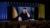 Presiden Ukraina Volodymyr Zelensky tampak di layar raksasa saat memberikan pidato pada awal konferensi internasional dua hari tentang rekonstruksi Ukraina, di Lugano, Swiss Senin 4 Juli 2022.