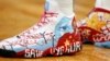 FILE - Former NBA player Enes Kanter Freedom, then with the Boston Celtics, wears shoes with a design in support of Uyghurs during a game against the Toronto Raptors, Nov. 10, 2021, in Boston. 