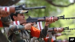 FILE - Indian army women recruits demonstrate their shooting skills as part of their training during a media visit in Bengaluru, March 31, 2021. 