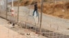 Image released by the Spanish Guardia Civil on Aug. 22, 2018 shows damage done to a fence dividing the Spanish enclave of Ceuta and Morocco.