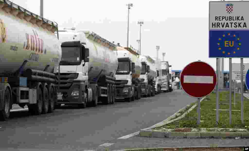 Meanwhile, tensions escalate between Serbia and Croatia as the long-time foes struggle to come up with a coherent way to deal with tens of thousands of migrants streaming through the Balkan nations to seek sanctuary in other parts of Europe. A long queue of vehicles waits at the no man's land at the Batrovci border crossing near Batrovci, about 100 km west from Belgrade, Serbia.