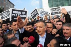 FILE - Zaman editor-in-chief Ekrem Dumanli, in foreground, the newspaper in Istanbul, Dec. 14, 2014.