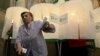 A woman leaves a voting booth at a polling station in Tbilisi, Georgia, October 1, 2012. 