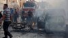 Syrians gather at the site of an explosion in the northeastern Kurdish city of Qamishli, Oct. 11, 2019. 