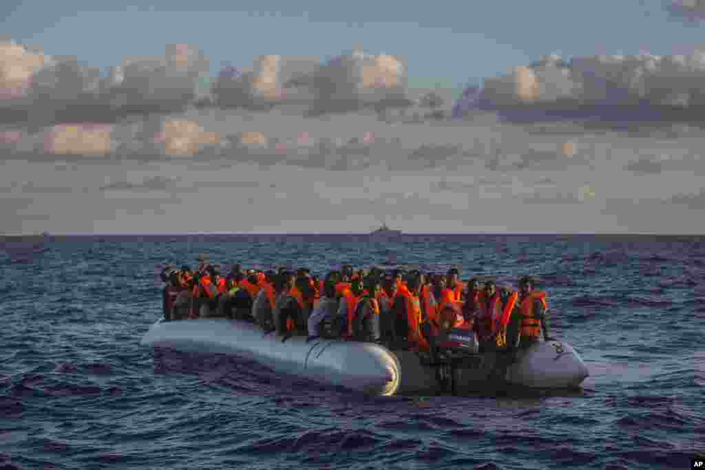 Sub-saharan refugees and migrants on an overcrowded dinghy wait to be rescued by a team of the Spanish NGO Proactiva Open Arms, 24 miles north of Sabratha, near Libya, July 19, 2016.