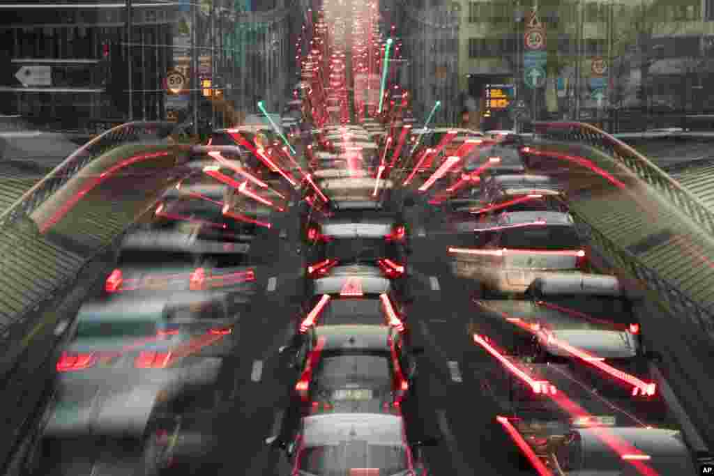 FILE - In this slow-shutter zoom effect photo taken Dec. 12, 2018, commuters backed up in traffic during the morning rush hour, in Brussels, a city that regularly experiences pollution alert warnings.