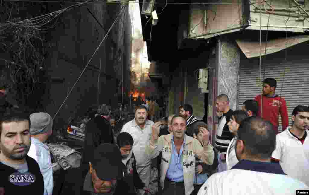A crowd gathers at the site of a blast in Jaramana district, near Damascus, in this handout photograph released by Syria&#39;s national news agency SANA, November 28, 2012. 