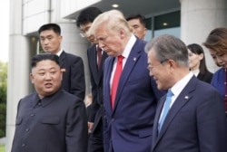 FILE - U.S. President Donald Trump, North Korean leader Kim Jong Un and South Korean President Moon Jae-in leave a meeting at the demilitarized zone separating the two Koreas, in Panmunjom, South Korea, June 30, 2019.