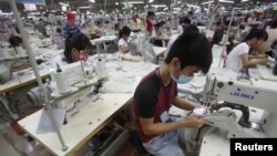FILE - Laborers work at a garment factory in Bac Giang province, near Hanoi, Vietnam, Oct. 21, 2015. 
